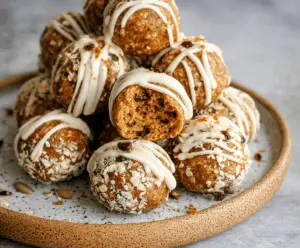 Delicious No-Bake Pumpkin Pie Energy Balls with cinnamon and fall spices on a white plate, perfect for healthy snacking