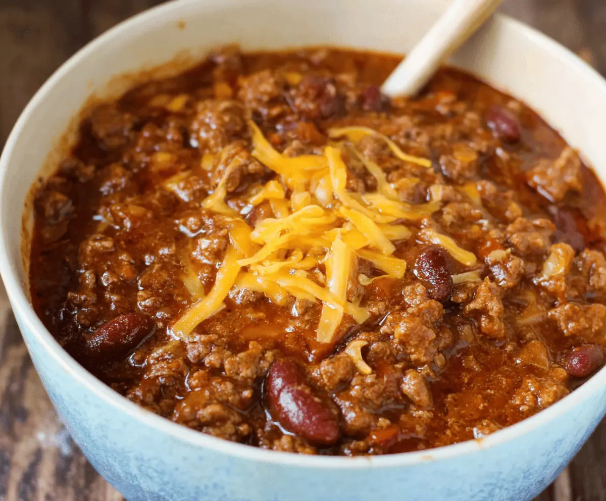 Delicious bowl of Pioneer Woman's famous homemade chili with beef, beans, and flavorful spices, served hot in a rustic bowl