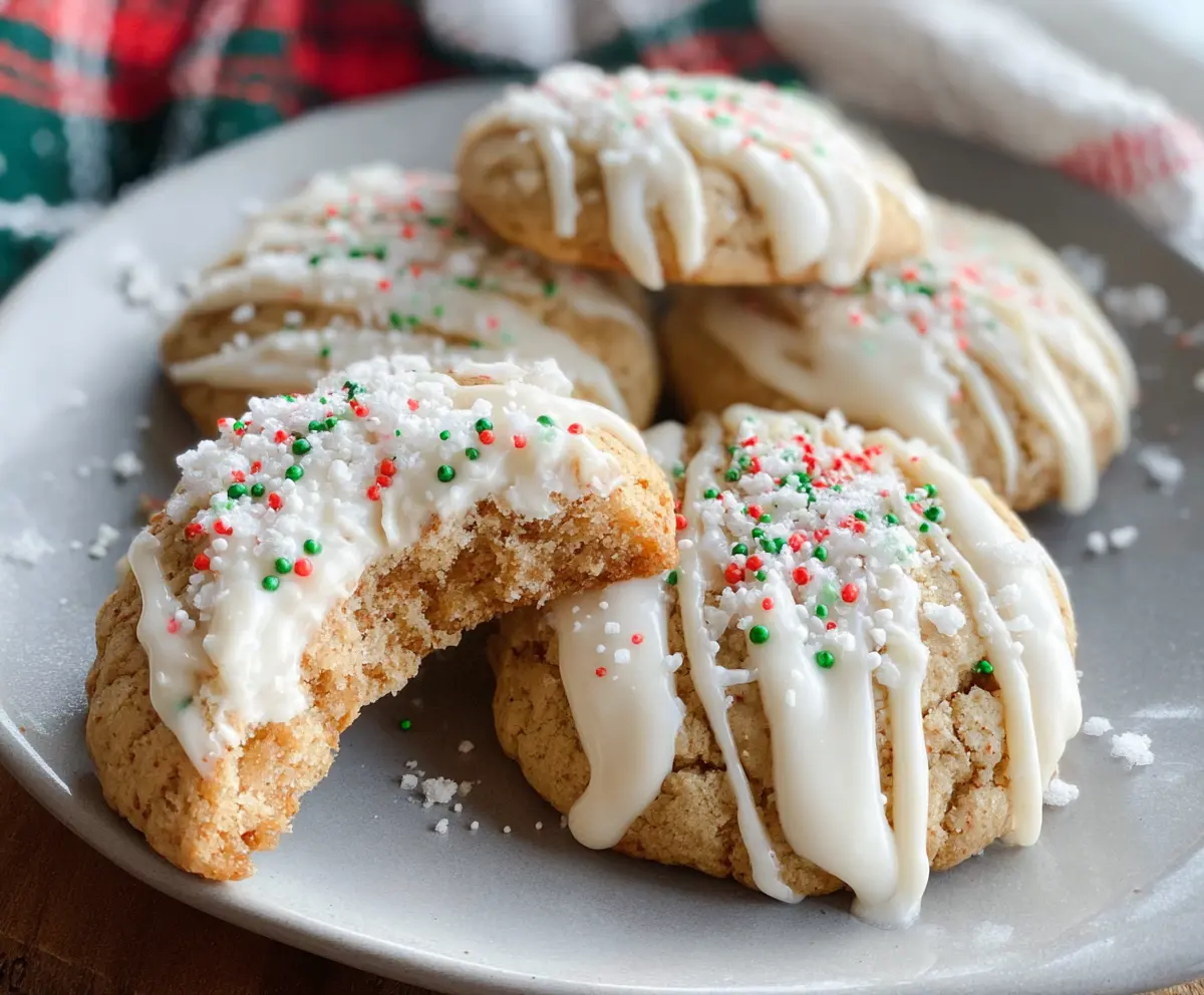 Delicious white chocolate covered eggnog cookies on a festive plate, perfect for holiday treats.