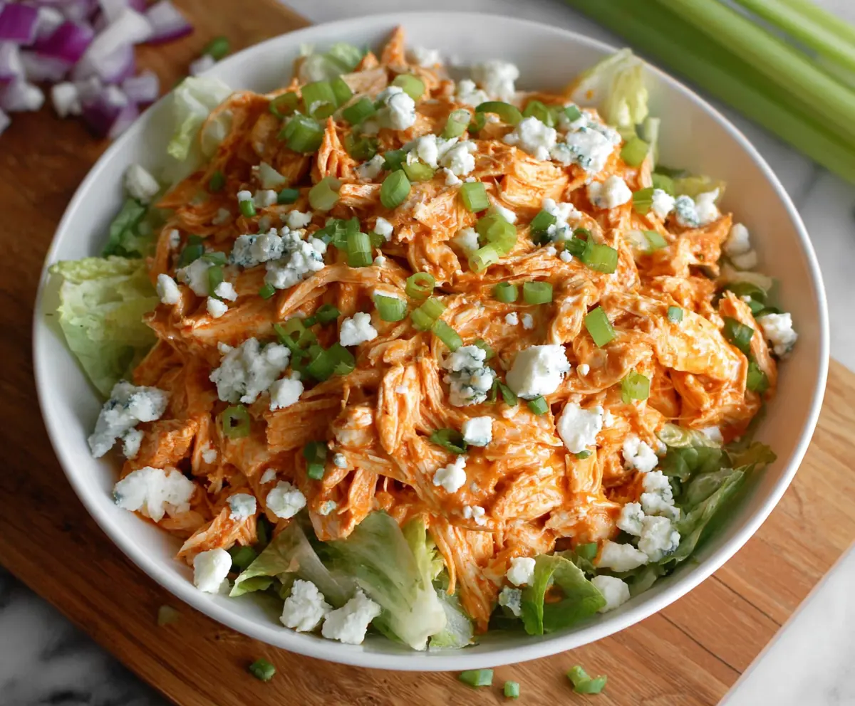 Delicious buffalo chicken salad with fresh vegetables and spicy buffalo sauce.