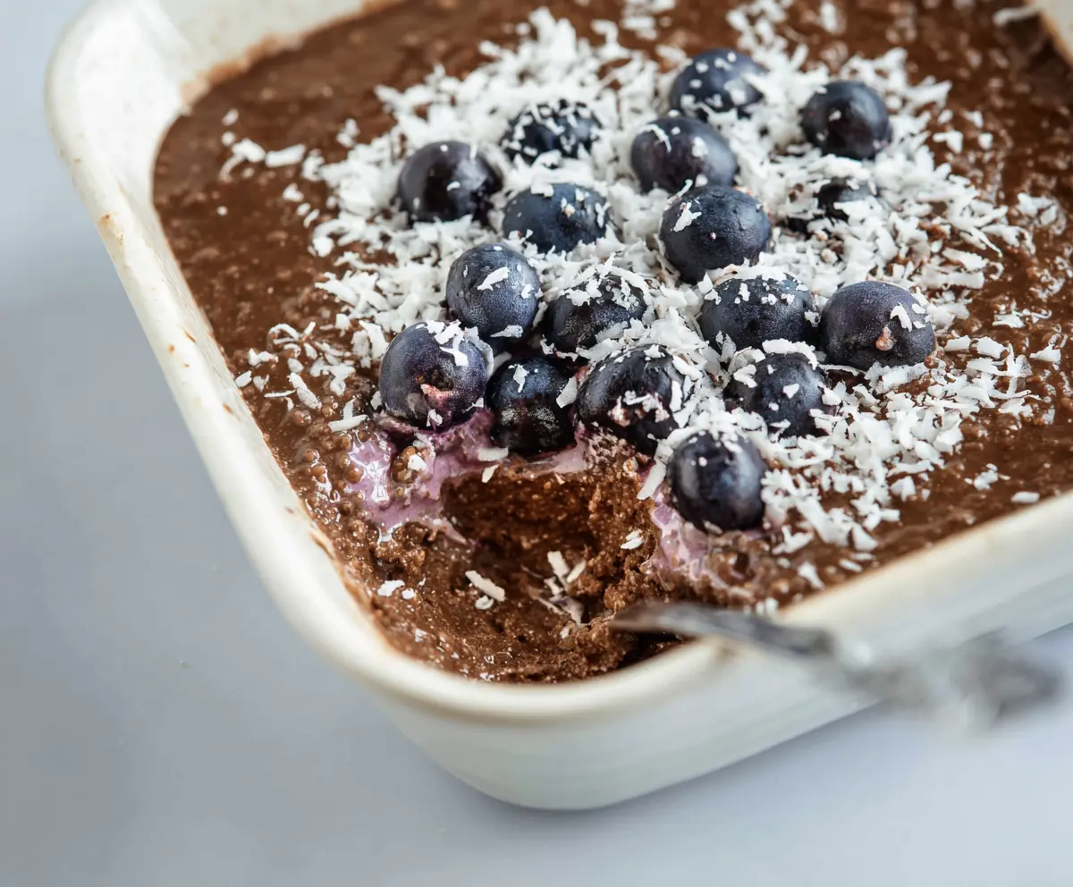Delicious chocolate coconut blueberry overnight Weetbix served in a glass bowl, perfect for a healthy breakfast.