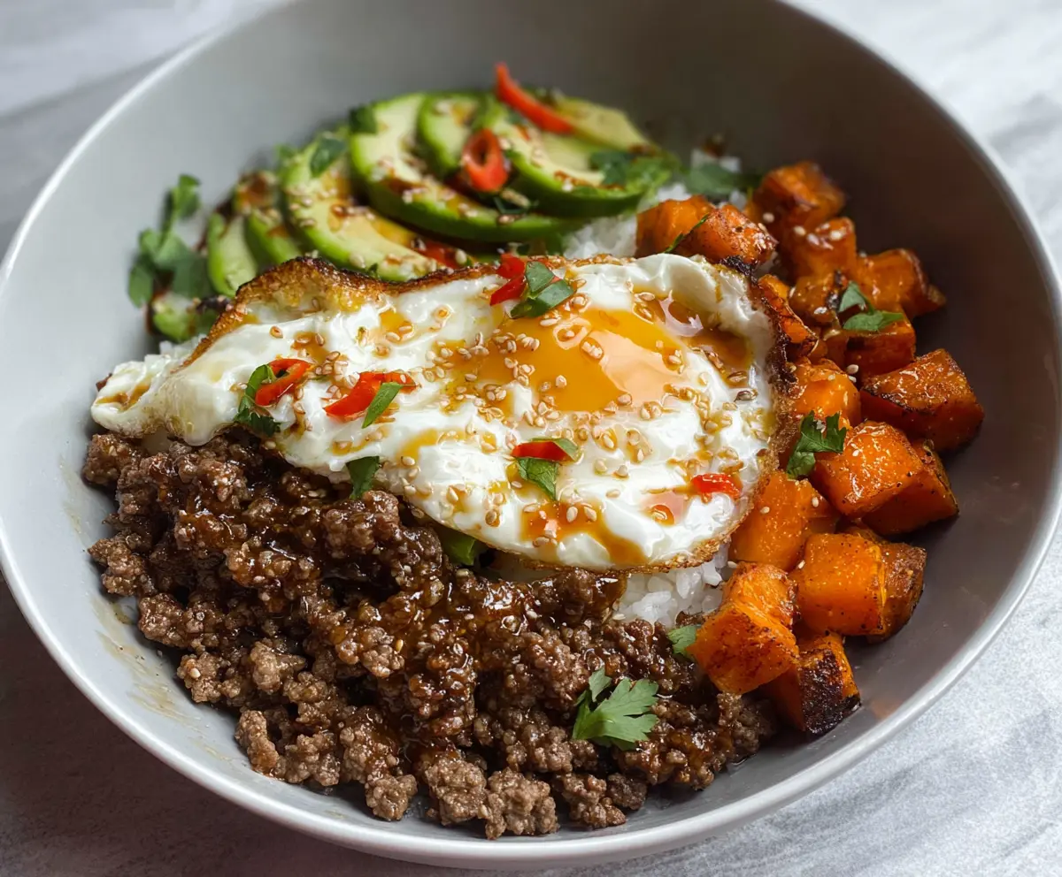 Delicious hot honey ground beef bowls topped with fresh herbs and vegetables